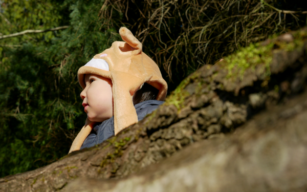 young toddler playing outside in nature setting