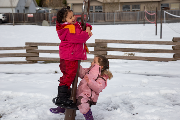 children playing outside in the snow