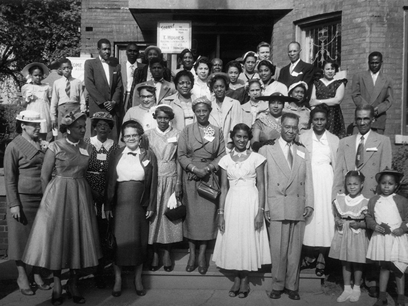 Image 12: Historical black and white photo of a group of well-dressed Black people. 