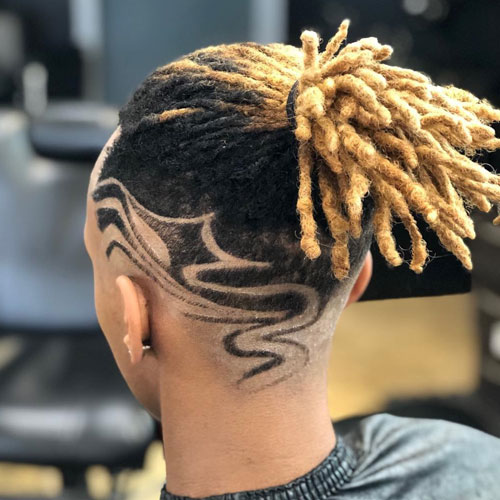 image 1: Back of young man’s head with shaved design and bleached dreadlocks