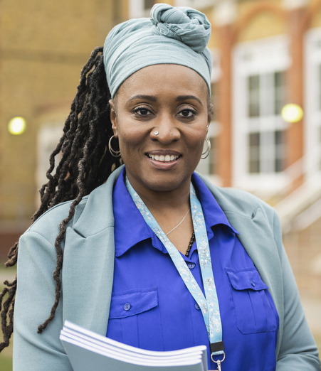 image 3: Older woman in professional dress, headscarf, and dreadlocks